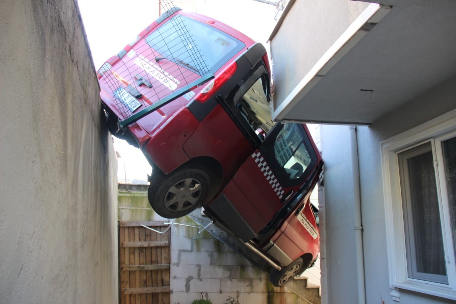 Freni boşalan dolmuş taksi, bina boşluğunda asılı kaldı